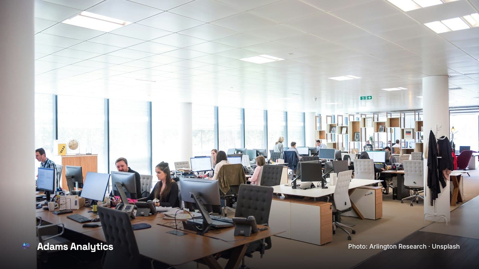 People working at desks in a bright open-plan office