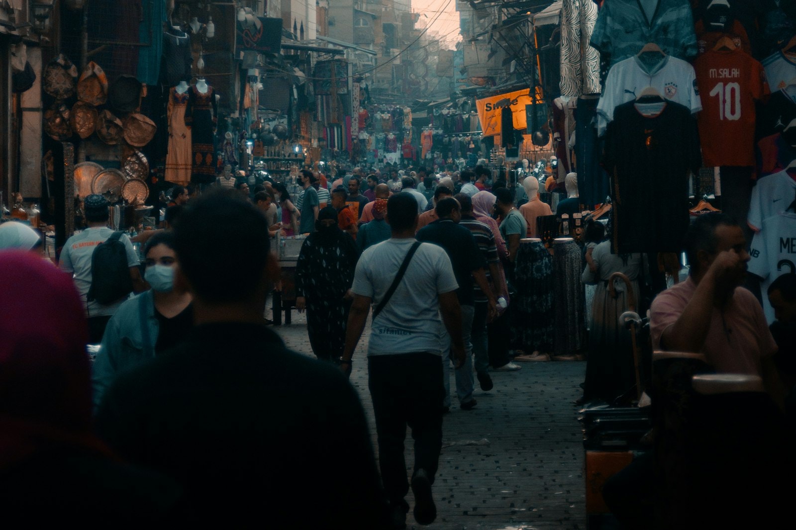 A crowded market street in Cairo with shops on both sides