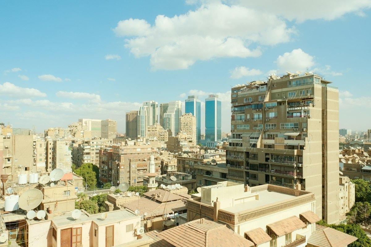 A view of Cairo with tall buildings under a blue sky