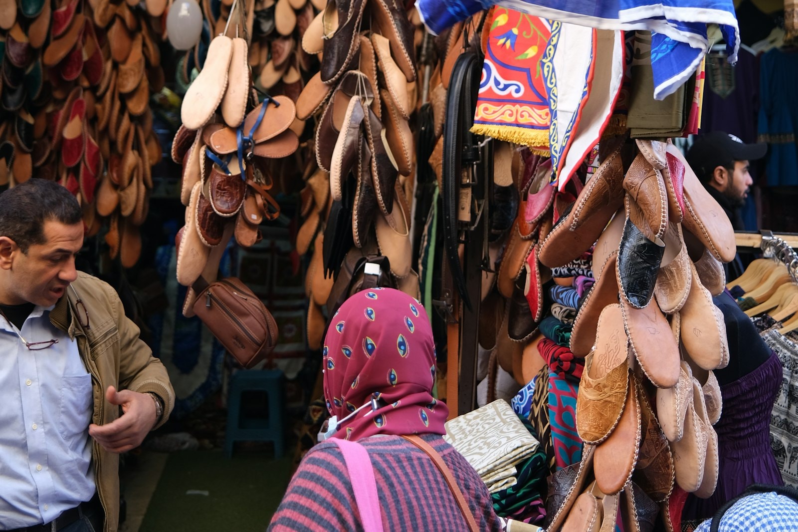 A busy shop in a Cairo market with goods hanging at the entrance
