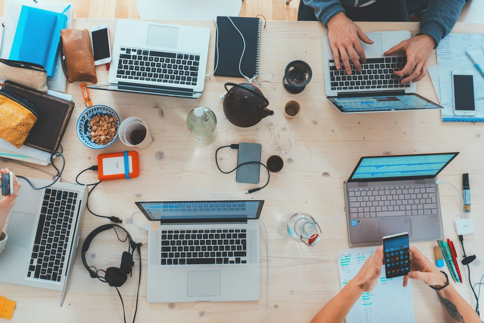 A team working on several laptops around one table