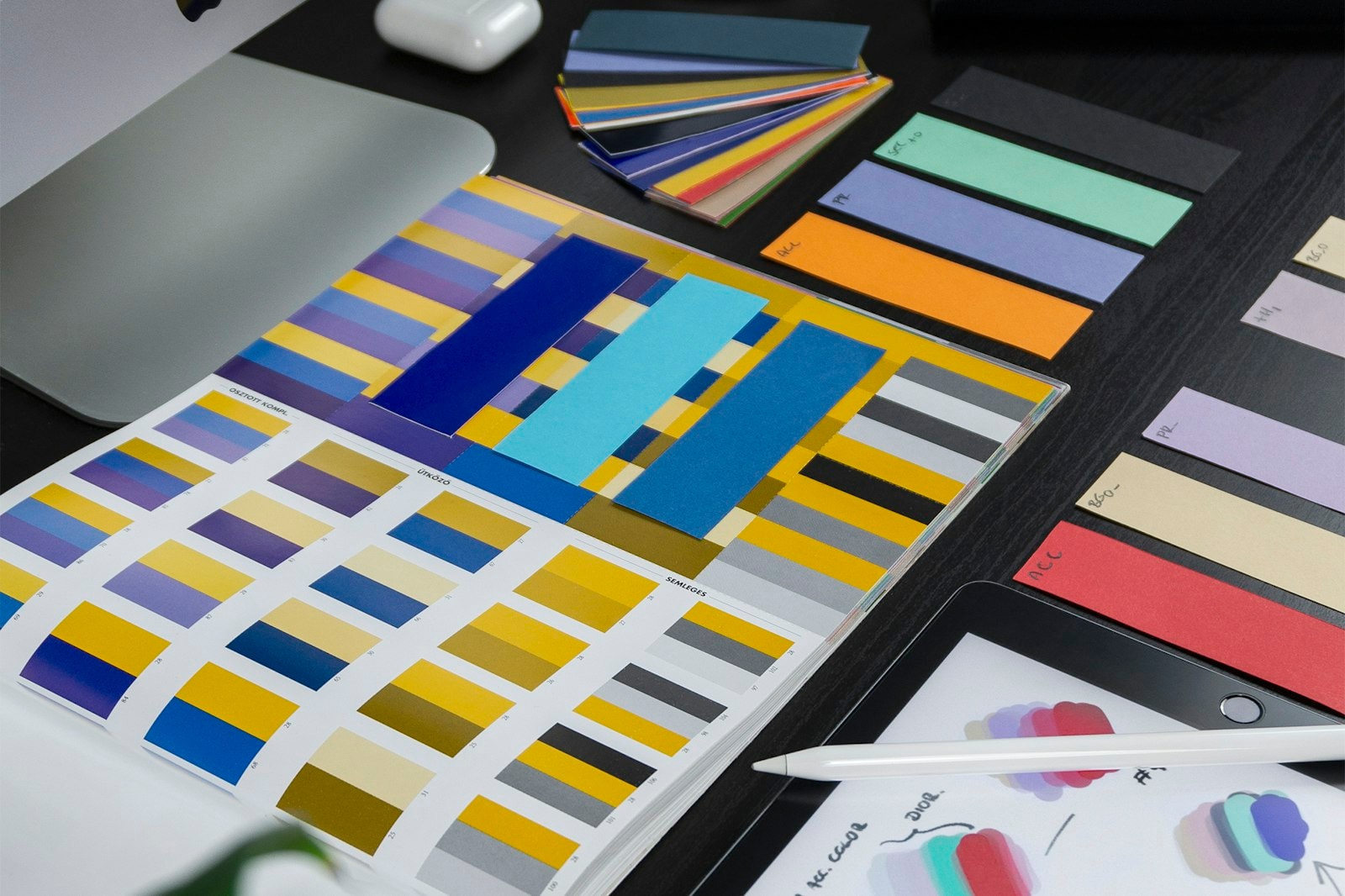 Printed color swatches and brand palettes on a desk