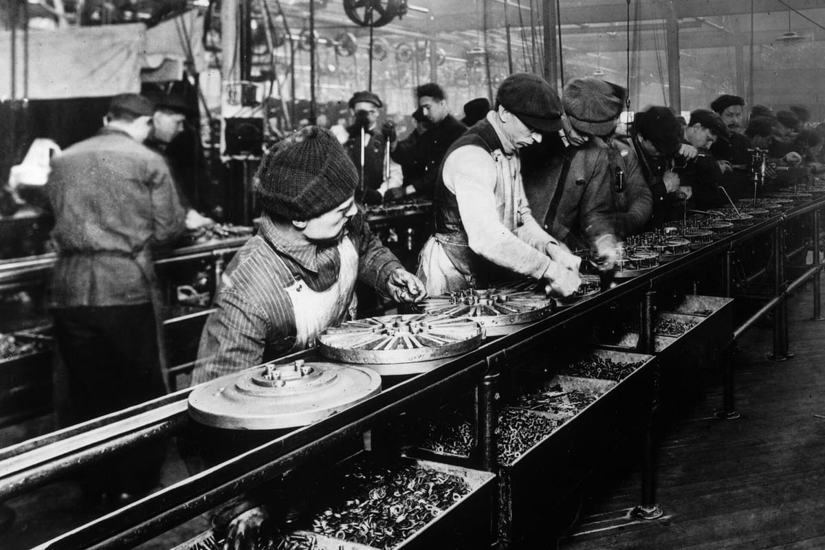 Workers on Ford’s moving assembly line in 1913
