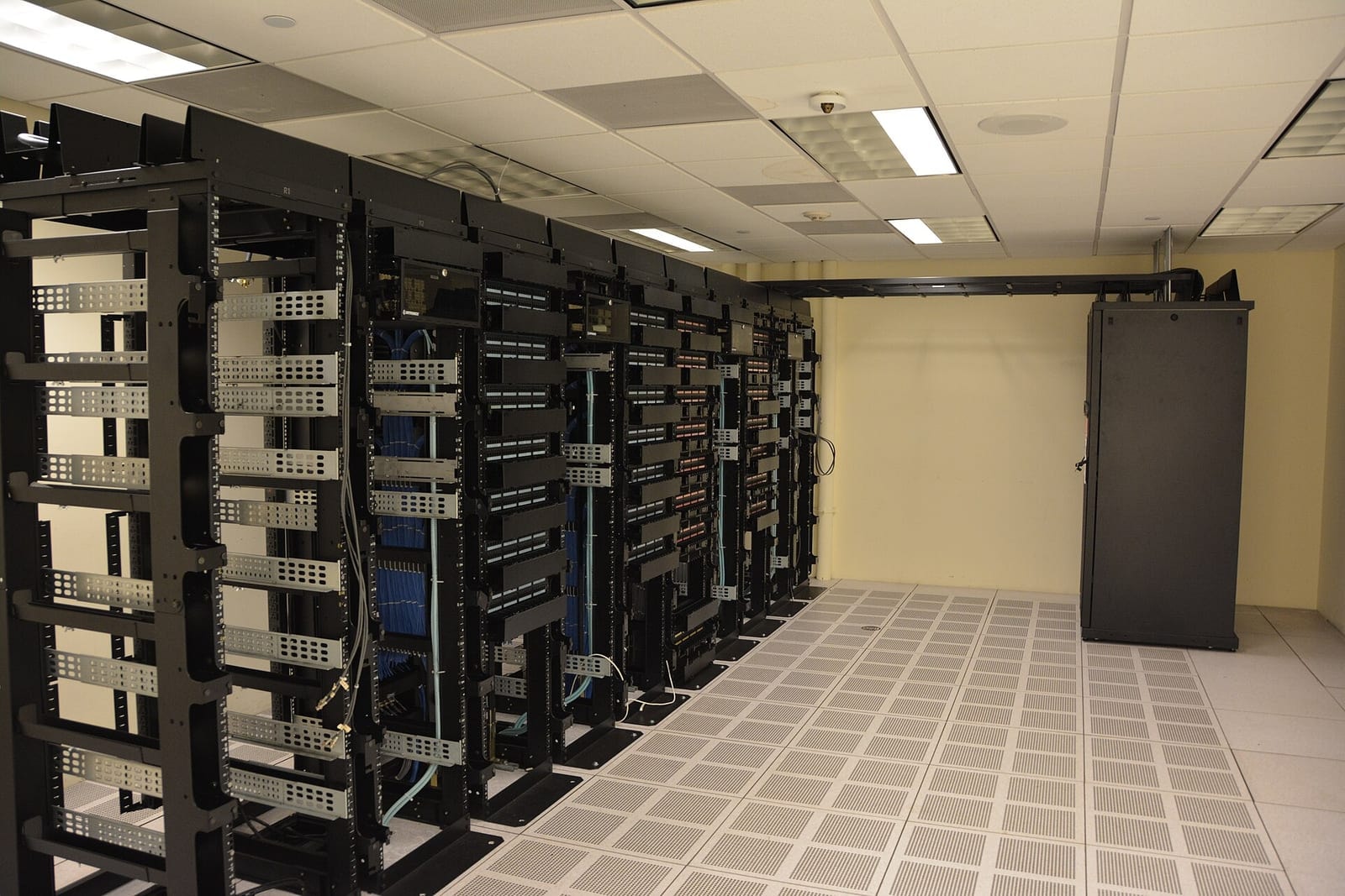 A long room of server racks inside a data center
