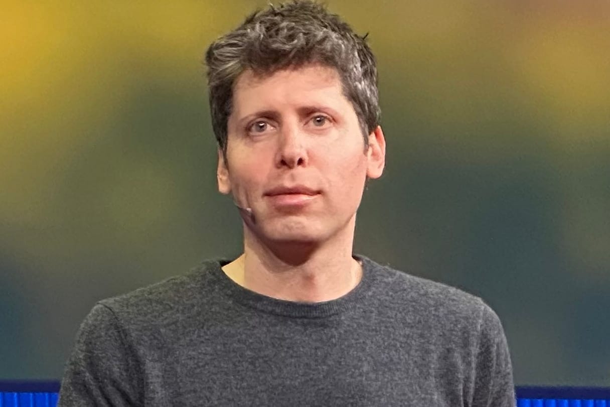 Sam Altman in a dark sweater, looking at the camera